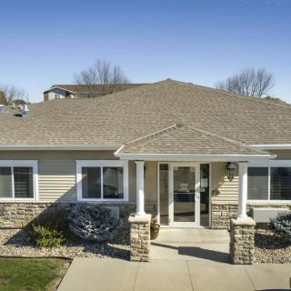 A single-story suburban house with a welcoming entrance and landscaped surroundings.