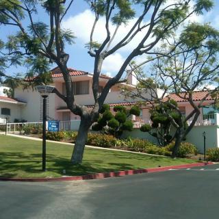 A suburban house with a well-maintained front yard and trees.