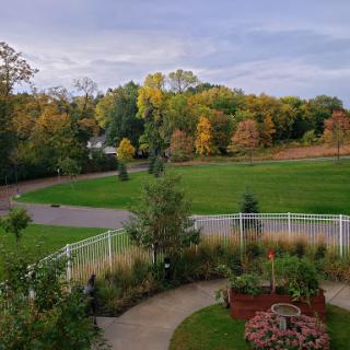 A serene view of a park showcasing the vibrant colors of autumn.