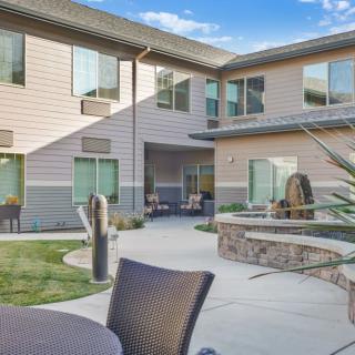 A peaceful courtyard with outdoor seating and modern architecture.