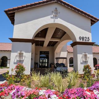 A beautiful entrance showcasing a blend of architectural elegance and vibrant landscaping.