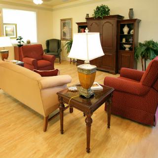 A cozy living room setup featuring a mix of comfortable chairs and a stylish lamp.