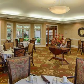 A well-decorated dining room with neatly arranged tables and chairs.