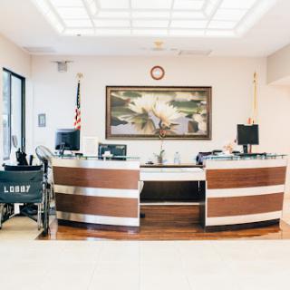 A modern reception area featuring elegant furniture and a decorative artwork.