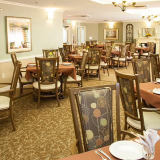 An elegant dining room setup with neatly arranged tables and chairs in a restaurant.