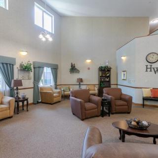 A spacious and well-lit living room featuring comfortable seating and elegant decor.