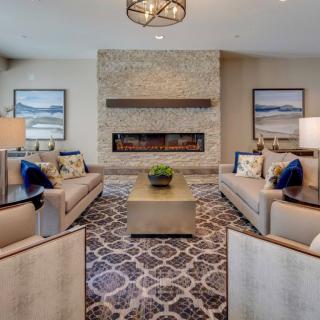 A modern living room with a central fireplace and comfortable seating arrangement.