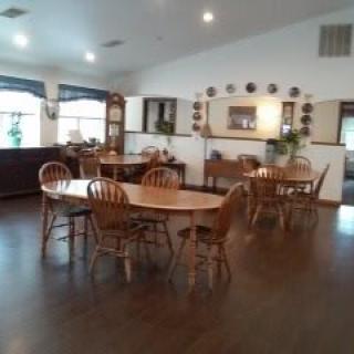 A cozy dining room with wooden tables and chairs.