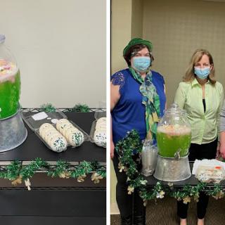 A festive gathering featuring green punch and treats, with attendees wearing masks.