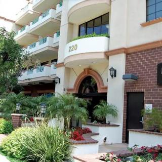 A well-maintained building entrance with lush landscaping.