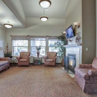 A cozy living room with comfortable seating, a fireplace, and a TV.
