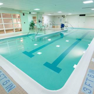 An indoor swimming pool with clear water and lane markings, ideal for exercise and relaxation.