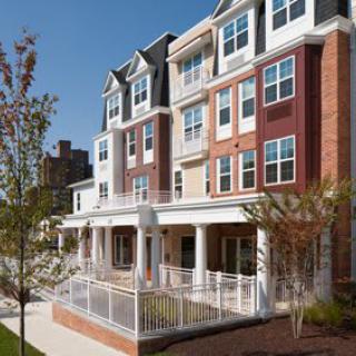 A modern residential apartment building with a diverse facade in an urban setting.