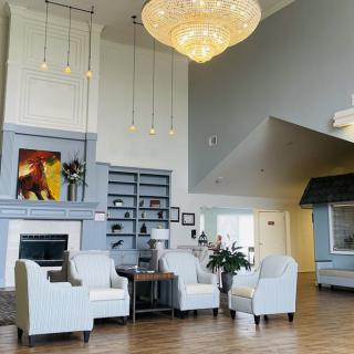A modern lobby with stylish seating, a large chandelier, and contemporary artwork.