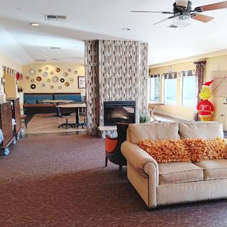 A cozy and modern living space featuring a comfortable sofa, a fireplace, and a dining area.