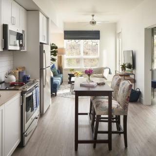 A modern, open-concept kitchen and dining area in an apartment.