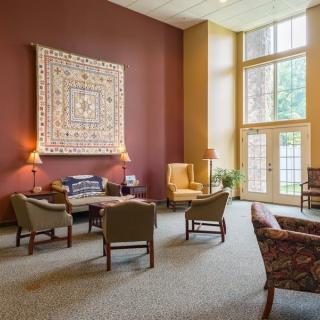A cozy living room with comfortable seating and large windows.