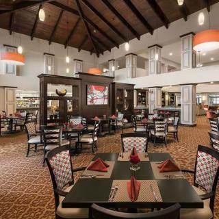 Elegant restaurant interior with neatly set tables and warm lighting.