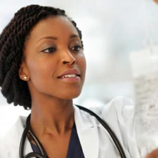 A doctor examining a medical solution.