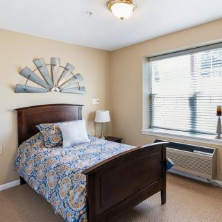 A neatly arranged bedroom with a single bed and decorative elements.