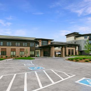 A modern facility with a welcoming entrance and accessible parking.