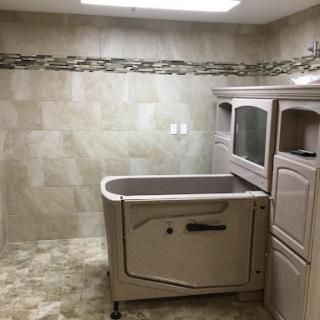 A spacious and modern bathroom featuring a built-in tub and elegant tile work.