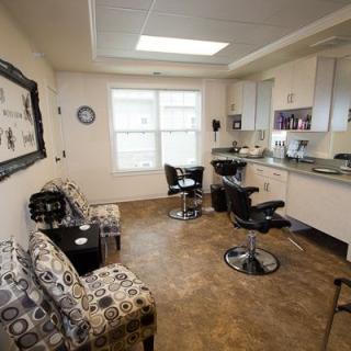 A cozy hair salon with styling stations and a waiting area.