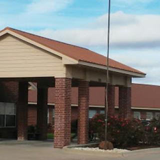 A view of the entrance to a residential building under a clear sky.