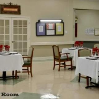 A neatly arranged dining room with tables and chairs set for guests.