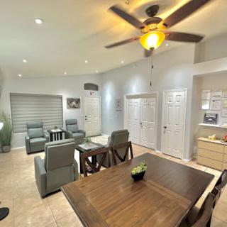 A stylish and modern living space featuring a cozy seating area, dining table, and elegant lighting.