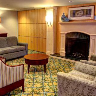 A cozy living room with comfortable seating and a fireplace.