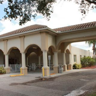 A stylish building featuring a welcoming entrance with arches and columns.