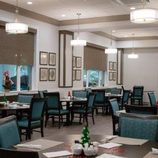 An empty restaurant dining area with neatly arranged tables and chairs.
