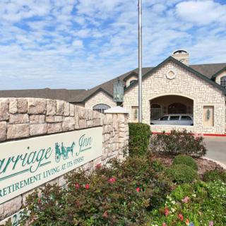 The entrance of a retirement living facility with well-maintained landscaping and clear signage.