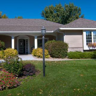 A suburban house with a well-maintained front yard and landscaping.