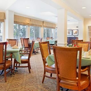 A well-lit dining area with neatly arranged tables and chairs in an indoor setting.