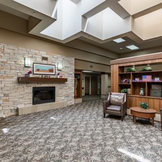 A modern lobby area featuring a fireplace and comfortable seating.