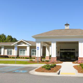 A modern healthcare facility with a welcoming entrance and landscaped surroundings.