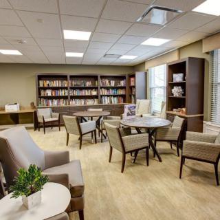 A modern library reading area with comfortable seating and bookshelves.