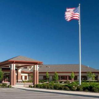 A building with an American flag flying on a clear day.