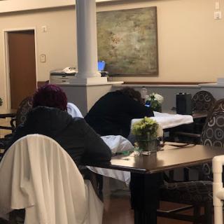 A cozy cafe setting where patrons are enjoying a quiet moment.
