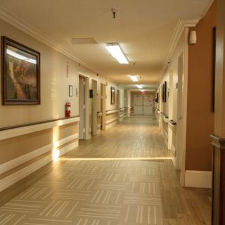 A well-lit hospital corridor with artwork on the walls.