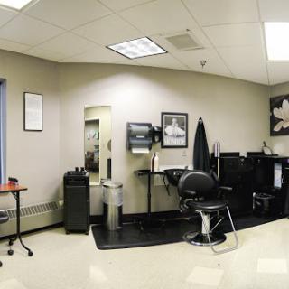 A modern and organized barber shop interior featuring styling chairs and workstations.