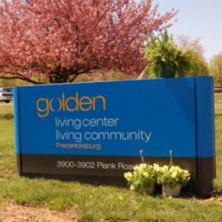 Sign for Golden Living Center Community surrounded by spring blossoms.