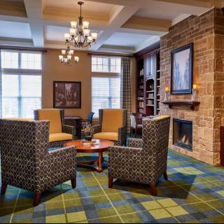 A cozy living room with a fireplace and comfortable seating arrangement.