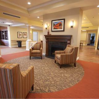 A cozy lobby area featuring a fireplace and comfortable seating.