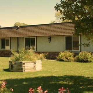 A suburban house with a well-maintained garden and lawn.
