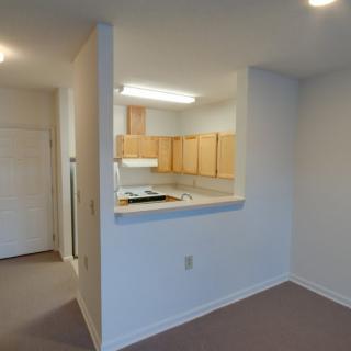 An open layout apartment with a view of the kitchen area.