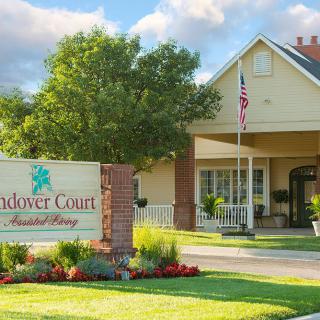 Entrance to Oakriver Court Assisted Living with a welcoming sign and well-maintained landscape.