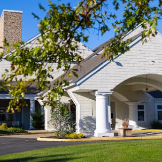 A charming residential building with elegant architectural features and lush greenery.